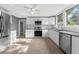 Modern kitchen with white cabinets, stainless steel appliances, and granite counters at 55 W Lemon St, Tarpon Springs, FL 34689