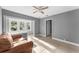 Living room with a brown couch and ceiling fan at 55 W Lemon St, Tarpon Springs, FL 34689