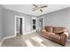 Living area with a brown couch and access to other rooms at 55 W Lemon St, Tarpon Springs, FL 34689