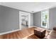 Bright living room with hardwood floors, brown leather couch, and view of kitchen at 55 W Lemon St, Tarpon Springs, FL 34689