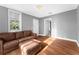 Living room features hardwood floors, brown leather sofa, and ample natural light at 55 W Lemon St, Tarpon Springs, FL 34689
