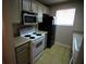 Kitchen boasts white appliances and light wood cabinets at 1829 Bough Ave # 4, Clearwater, FL 33760