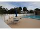 Relaxing community pool with ample seating and patio area at 1829 Bough Ave # 4, Clearwater, FL 33760