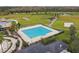Community lap pool with lounge chairs and surrounding landscaping at 21811 Lyonia Ln, Land O Lakes, FL 34637