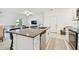 Kitchen island with granite countertop, stainless steel dishwasher, and sink at 21811 Lyonia Ln, Land O Lakes, FL 34637
