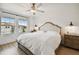 Main bedroom with king bed and ceiling fan at 21811 Lyonia Ln, Land O Lakes, FL 34637