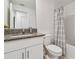 Bathroom with granite countertop and white vanity at 21811 Lyonia Ln, Land O Lakes, FL 34637