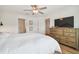 Main bedroom with king bed and large TV at 21811 Lyonia Ln, Land O Lakes, FL 34637