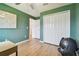 Guest bedroom with green walls and hardwood floors at 21811 Lyonia Ln, Land O Lakes, FL 34637