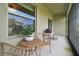 Covered patio with wicker furniture and potted plant at 21811 Lyonia Ln, Land O Lakes, FL 34637