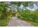 Yellow house with a driveway and landscaping at 7313 S Obrien St, Tampa, FL 33616