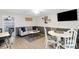 Bright dining area with white table and navy blue sofa at 14462 91St Ave, Seminole, FL 33776