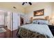 Bright bedroom with wooden floors, ceiling fan, and ensuite bathroom access at 6141 Bahia Del Mar Blvd # 232, St Petersburg, FL 33715