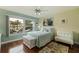 Bedroom with white bed, light teal walls, and white sofa at 6141 Bahia Del Mar Blvd # 232, St Petersburg, FL 33715