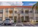 Two-story condo building with tile roof and stairs leading to upper and lower units at 6141 Bahia Del Mar Blvd # 232, St Petersburg, FL 33715