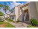 View of the side of a two-story condo building with stairs leading to a unit at 6141 Bahia Del Mar Blvd # 232, St Petersburg, FL 33715