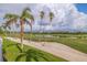 View of golf course with palm trees and sand traps under partly cloudy sky at 6141 Bahia Del Mar Blvd # 232, St Petersburg, FL 33715