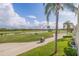 Scenic view of the golf course with palm trees and a water feature at 6141 Bahia Del Mar Blvd # 232, St Petersburg, FL 33715