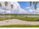 Golfers enjoying the course with palm trees and a pond at 6141 Bahia Del Mar Blvd # 232, St Petersburg, FL 33715