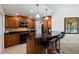 Kitchen with wood cabinets, black countertops, and stainless steel appliances at 6141 Bahia Del Mar Blvd # 232, St Petersburg, FL 33715
