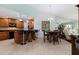 Kitchen and dining area with wooden cabinets, black countertops, and bar seating at 6141 Bahia Del Mar Blvd # 232, St Petersburg, FL 33715