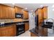 Close-up of the kitchen's wood cabinets, black appliances, and tile backsplash at 6141 Bahia Del Mar Blvd # 232, St Petersburg, FL 33715