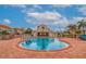 Community pool with lounge chairs, umbrellas, and a clubhouse at 6141 Bahia Del Mar Blvd # 232, St Petersburg, FL 33715
