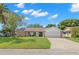 Single story home with a two-car garage and neat lawn at 12218 Buttonwood Row, Hudson, FL 34667