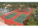 Aerial view of two well-maintained tennis courts at 12218 Buttonwood Row, Hudson, FL 34667