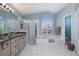 Bathroom with soaking tub, shower, and granite vanity at 3623 Doral St, Palm Harbor, FL 34685