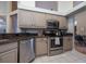 Modern kitchen with stainless steel appliances and granite countertops at 3623 Doral St, Palm Harbor, FL 34685
