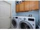 Laundry room with washer, dryer, and ample storage cabinets at 3623 Doral St, Palm Harbor, FL 34685