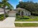 One-story house with a two-car garage and well-maintained landscaping at 3623 Doral St, Palm Harbor, FL 34685