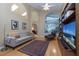 Living room features hardwood floors, built-in shelving and a large TV at 3623 Doral St, Palm Harbor, FL 34685