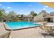 Community pool with lounge chairs and patio tables at 750 N Village N Dr # 106, St Petersburg, FL 33716