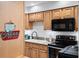 Modern kitchen with light wood cabinets, a double sink, and stainless steel appliances at 750 N Village N Dr # 106, St Petersburg, FL 33716