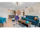 Open living area with dining space and a teal couch at 750 N Village N Dr # 106, St Petersburg, FL 33716