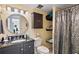 Bathroom with granite countertop, large mirror and shower at 750 N Village N Dr # 106, St Petersburg, FL 33716