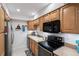 Well-equipped kitchen with light wood cabinets and modern appliances at 750 N Village N Dr # 106, St Petersburg, FL 33716