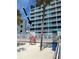 Exterior view of beachfront hotel with palm trees at 10650 Gulf Blvd # 340, Treasure Island, FL 33706