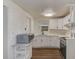 White kitchen with stainless steel appliances and brick accent wall at 10162 115Th Ave, Largo, FL 33773