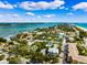 A stunning aerial view of a coastal neighborhood with beach access and blue ocean views at 106 19Th Ave, St Pete Beach, FL 33706