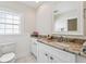 Bright bathroom with granite countertop, a sink, and tiled floors at 106 19Th Ave, St Pete Beach, FL 33706
