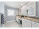 Bathroom featuring dual sinks, granite countertops, and a walk-in shower at 106 19Th Ave, St Pete Beach, FL 33706