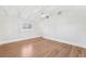 Bright bedroom with hardwood floors, white walls, a ceiling fan, and large windows at 106 19Th Ave, St Pete Beach, FL 33706