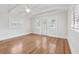 Bright bedroom features hardwood floors, a vaulted ceiling, and double doors to balcony at 106 19Th Ave, St Pete Beach, FL 33706