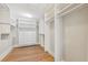 Spacious walk-in closet with custom shelving and hardwood flooring at 106 19Th Ave, St Pete Beach, FL 33706