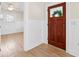 Entryway featuring light wood floors, wood door with glass, and white walls at 106 19Th Ave, St Pete Beach, FL 33706
