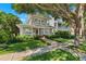 Charming two-story home with a welcoming front porch and beautiful landscaping at 106 19Th Ave, St Pete Beach, FL 33706