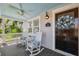 Inviting front porch with rocking chairs and a ceiling fan, perfect for relaxing at 106 19Th Ave, St Pete Beach, FL 33706